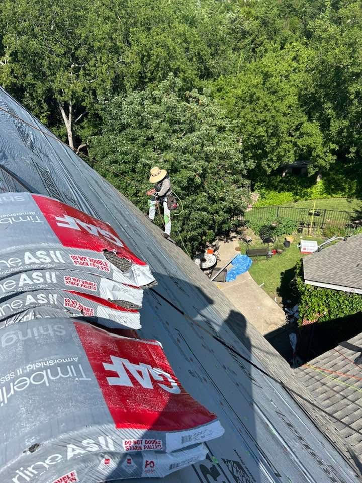 Bacon Roofing roofer installing new GAF shingles